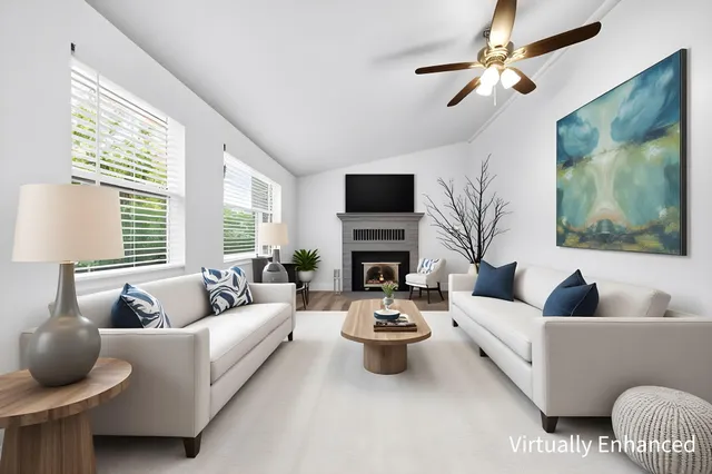 a living room with furniture a fireplace and a flat screen tv