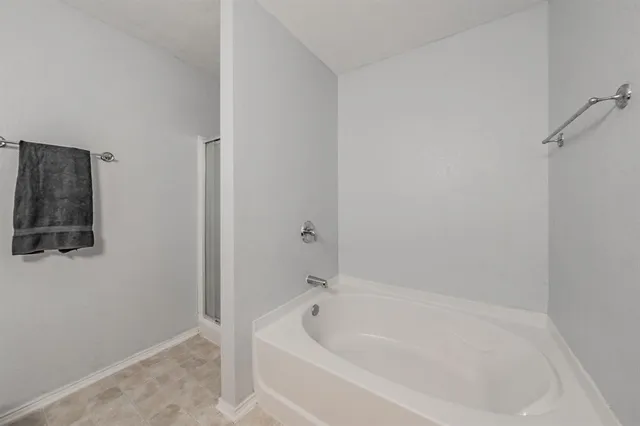 a white bath tub sitting next to a shower