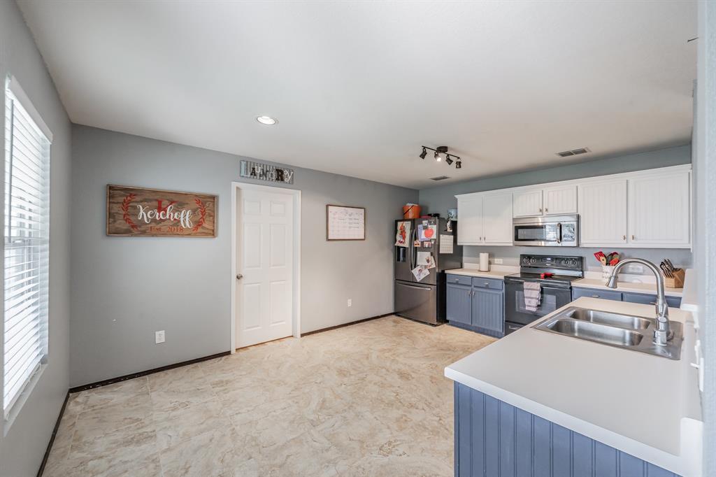 12617 Kingsgate Drive Rhome, TX 76078 - Photo 17 of 39 a view of kitchen with furniture and wooden floor