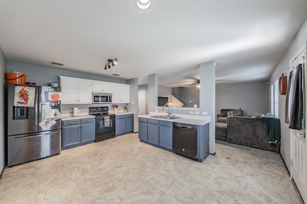 12617 Kingsgate Drive Rhome, TX 76078 - Photo 18 of 39 a kitchen with a refrigerator sink and stove top oven