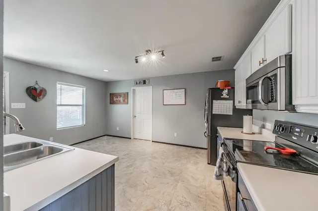 a view of a kitchen with workspace and a window