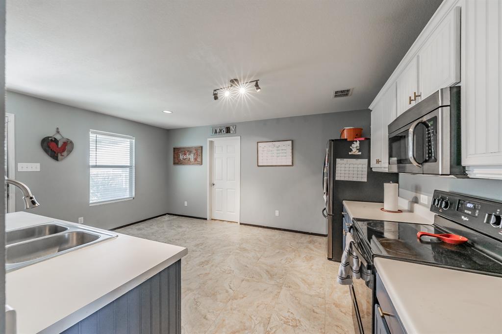 12617 Kingsgate Drive Rhome, TX 76078 - Photo 21 of 39 a view of a kitchen with workspace and a window