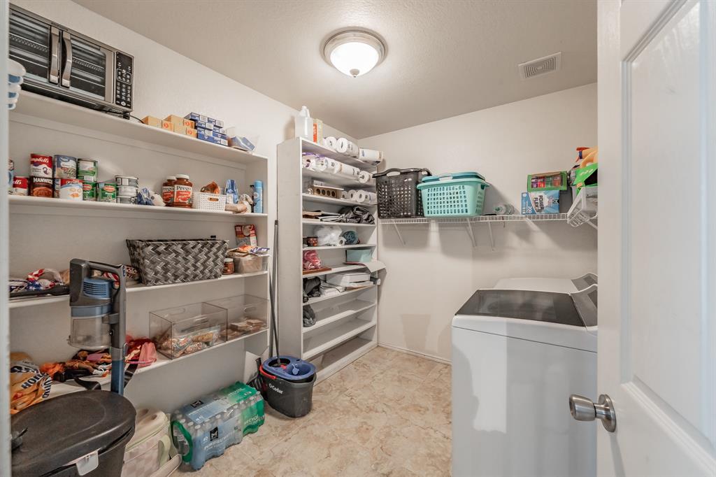 12617 Kingsgate Drive Rhome, TX 76078 - Photo 22 of 39 a kitchen with a refrigerator and stove