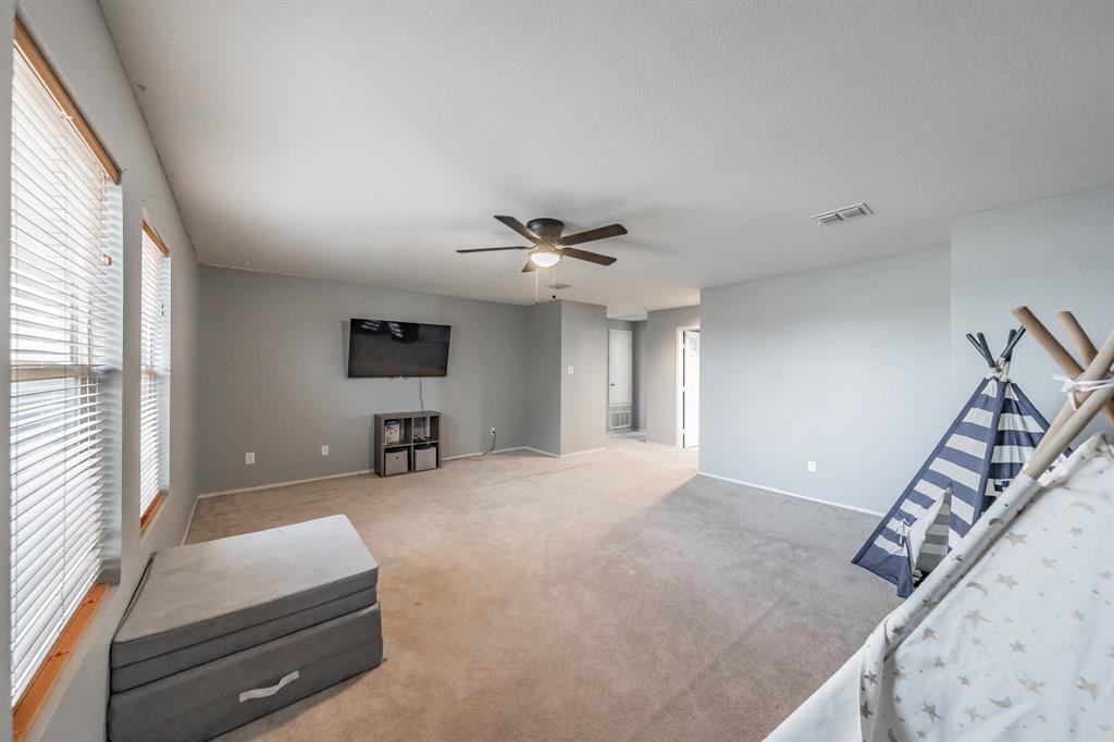 12617 Kingsgate Drive Rhome, TX 76078 - Photo 24 of 39 a living room with furniture and a flat screen tv