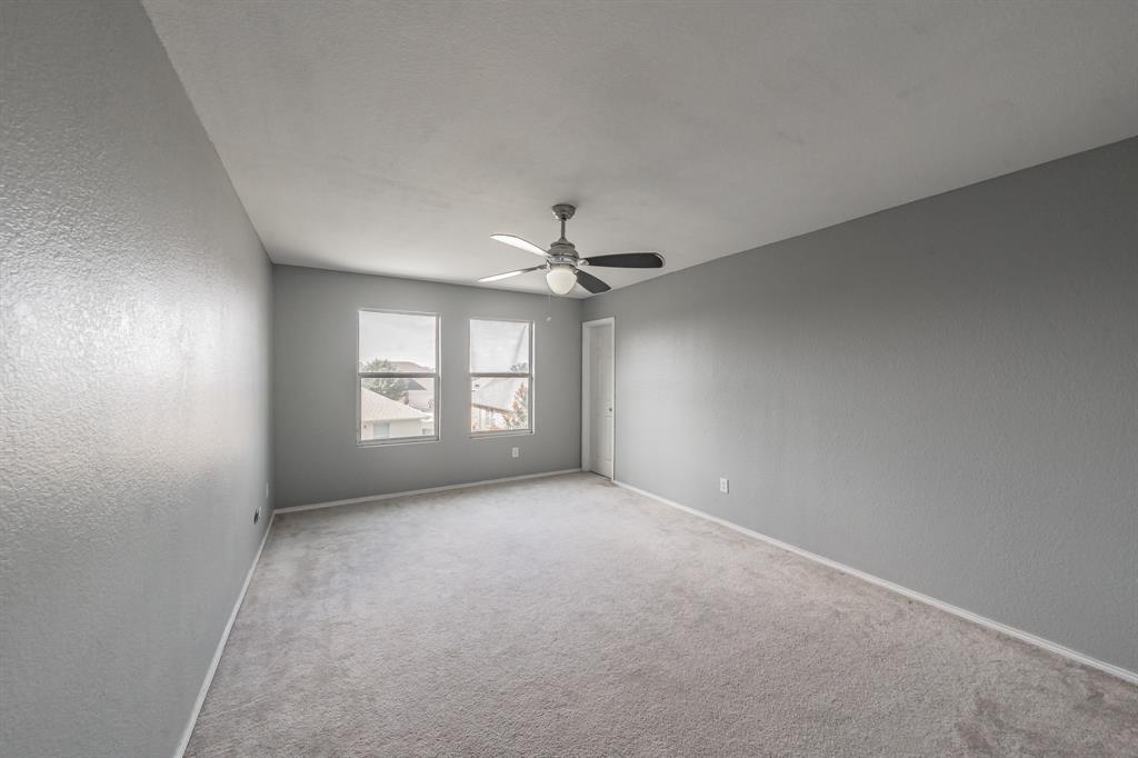 12617 Kingsgate Drive Rhome, TX 76078 - Photo 28 of 39 an empty room with windows and fan