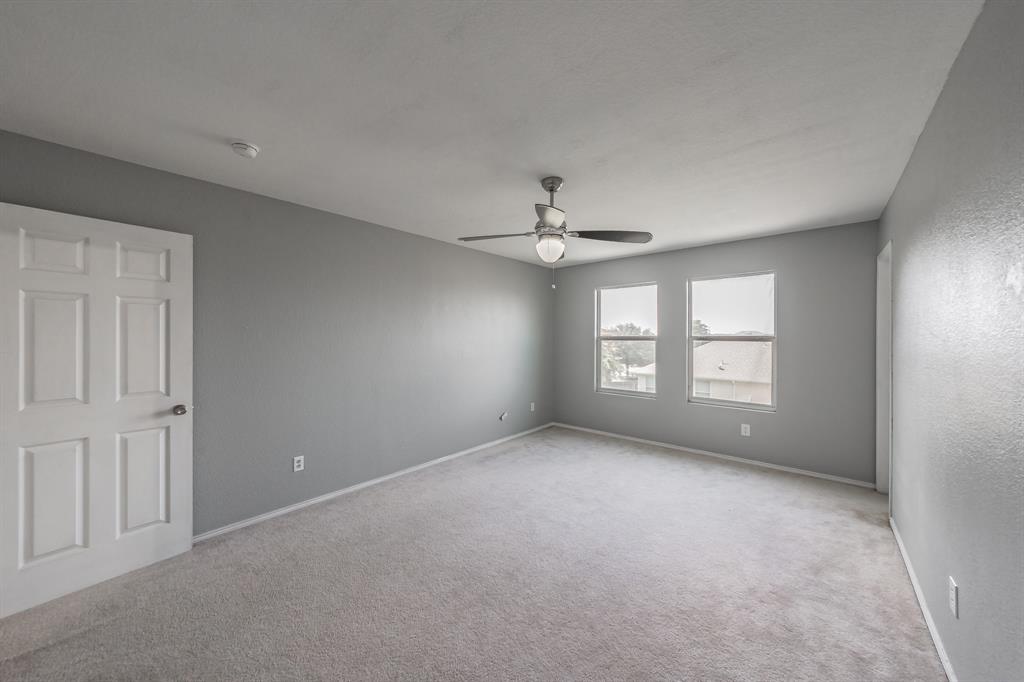 12617 Kingsgate Drive Rhome, TX 76078 - Photo 29 of 39 an empty room with a window and a ceiling fan