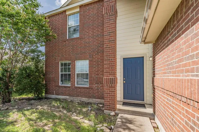 a view of a house with a door and wooden walls