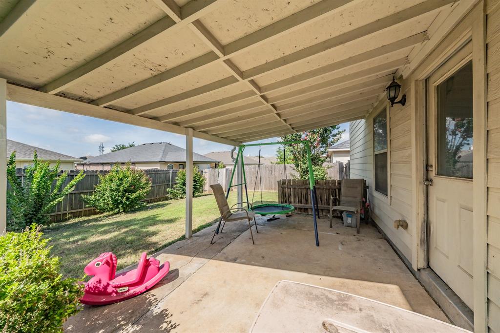 12617 Kingsgate Drive Rhome, TX 76078 - Photo 34 of 39 a view of a patio with table and chairs potted plants with floor to ceiling window and potted plants