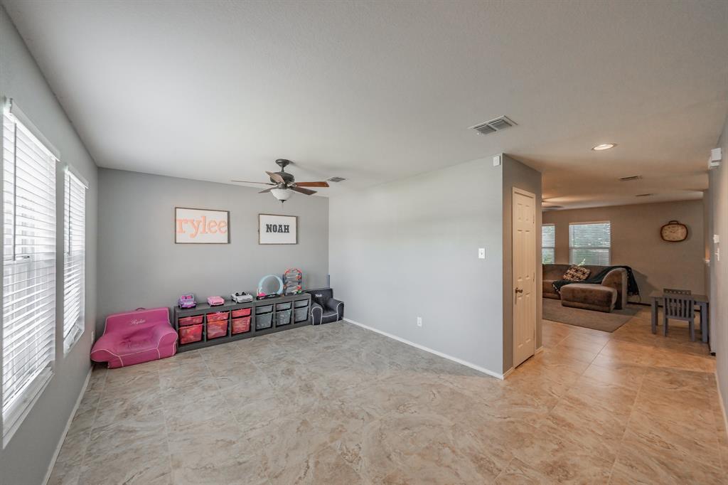 12617 Kingsgate Drive Rhome, TX 76078 - Photo 4 of 39 a bedroom with furniture and a window