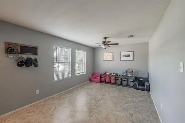 a living room with furniture toys and a window