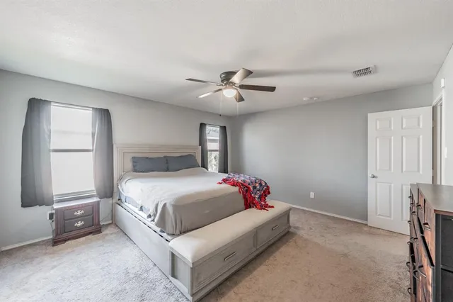 a bedroom with a bed and window