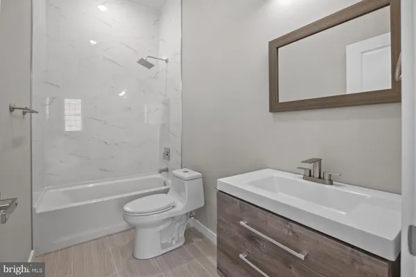 a bathroom with a sink a toilet and a bathtub