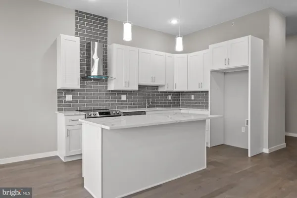 a kitchen with stainless steel appliances a sink stove and cabinets