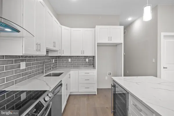 a kitchen with a sink a stove and cabinets