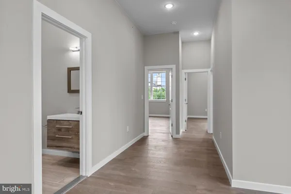 a view of a hallway with wooden floor