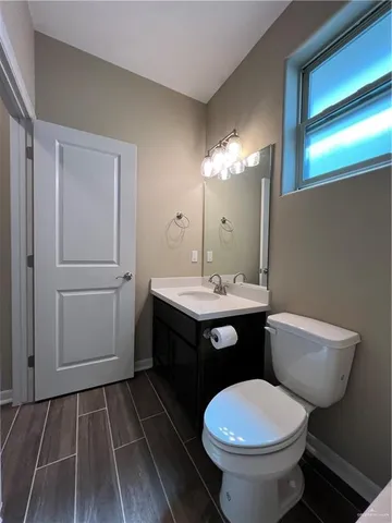 a bathroom with a toilet sink and mirror