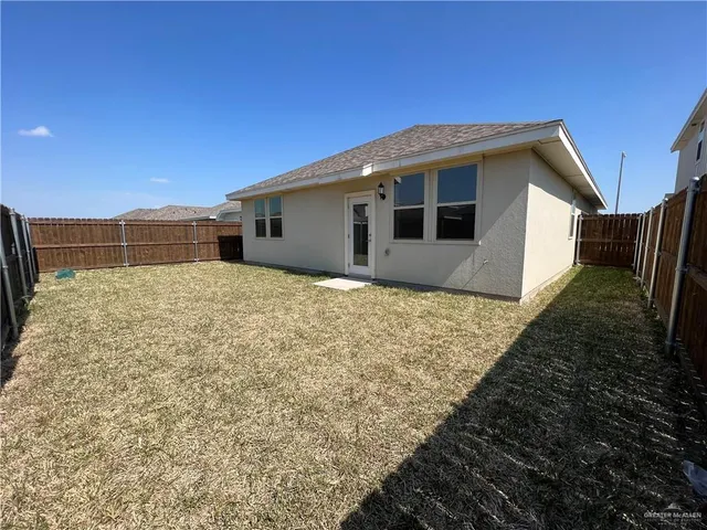 a backyard of a house with large trees