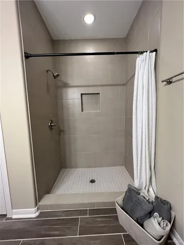 a bathroom with a shower and a toilet