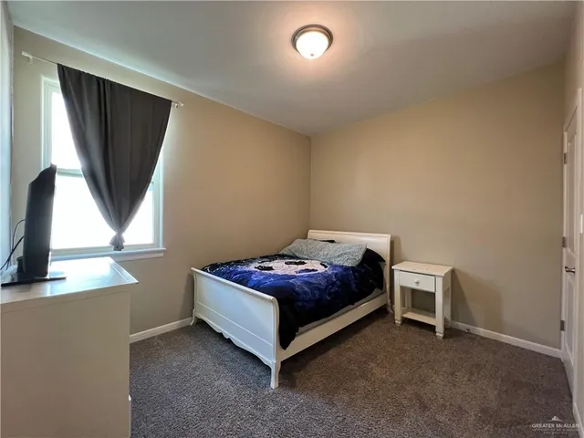 a living room with a bed furniture and a window