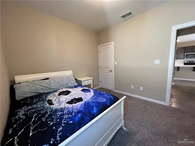 a bedroom with a bed and a dresser