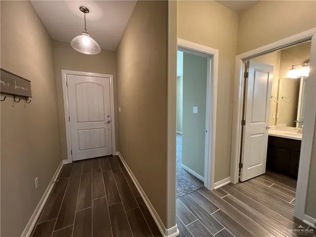 a view of a room with wooden floor and cabinet