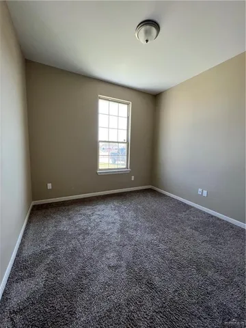 an empty room with a empty space and windows