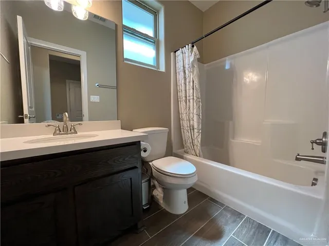 a bathroom with a sink toilet a mirror and shower