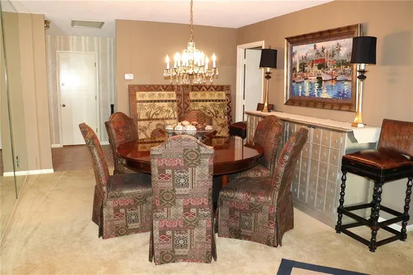 a view of a dining room with furniture and chandelier