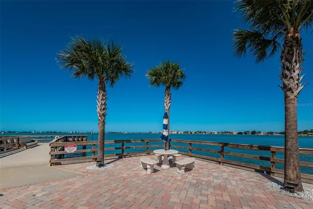 an aerial view of a building with outdoor space and lake view