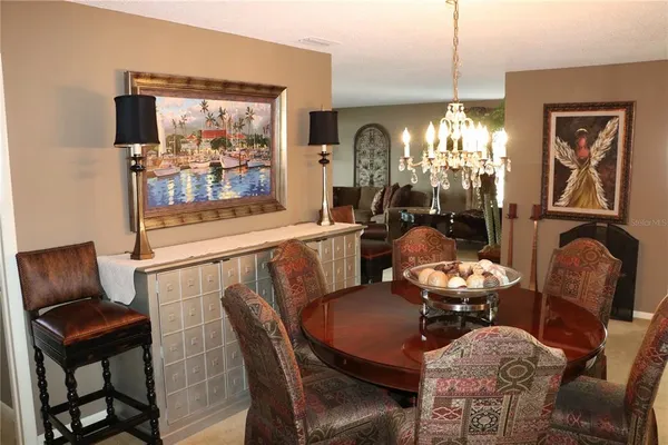 a dining room with furniture a chandelier and window