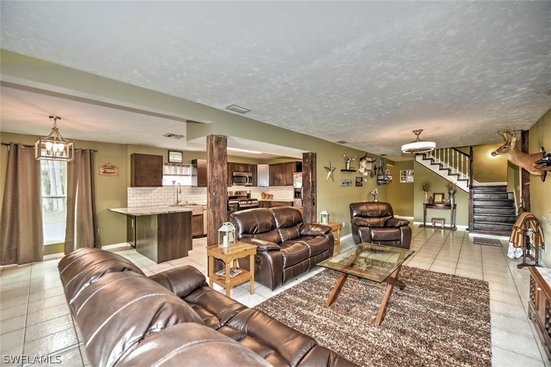 5320 Obannon Road Fort Myers, FL 33905 - Photo 1 of 28 a living room with furniture and a fireplace