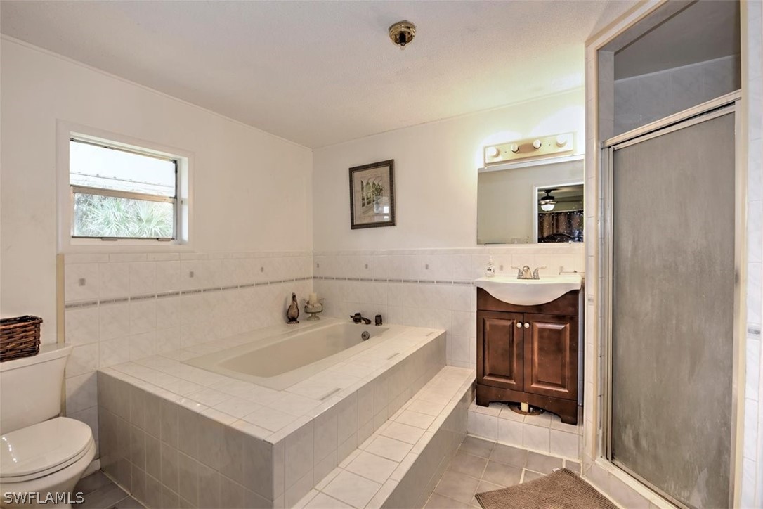 5320 Obannon Road Fort Myers, FL 33905 - Photo 13 of 28 a bathroom with a sink a toilet and shower