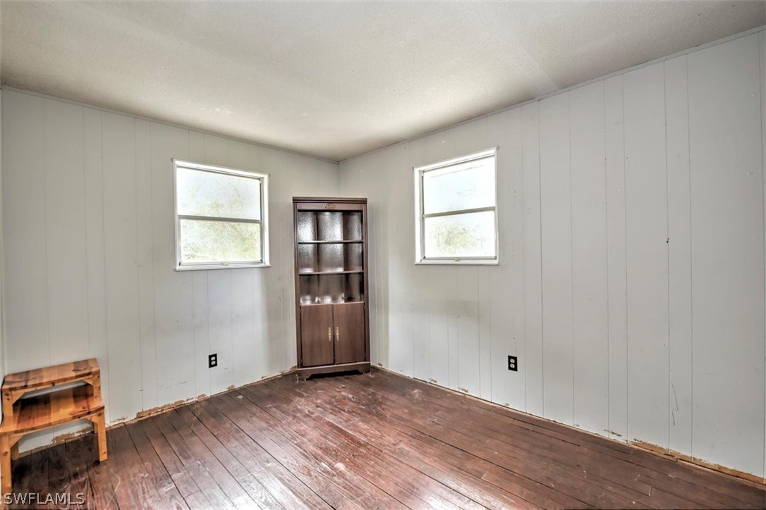 5320 Obannon Road Fort Myers, FL 33905 - Photo 18 of 28 a view of an empty room with a window and wooden floor