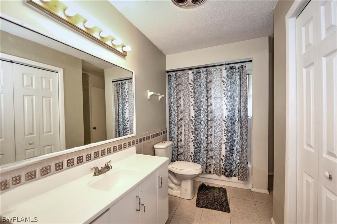 5320 Obannon Road Fort Myers, FL 33905 - Photo 20 of 28 a bathroom with a sink a toilet a mirror and shower