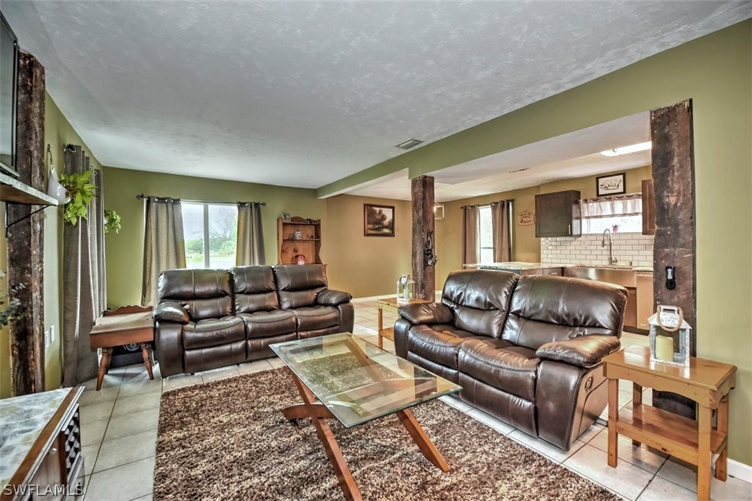 5320 Obannon Road Fort Myers, FL 33905 - Photo 2 of 28 a living room with furniture and a rug