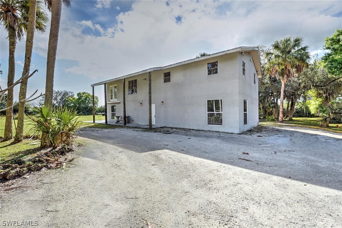 5320 Obannon Road Fort Myers, FL 33905 - Photo 22 of 28 a front view of a house with a yard and garage