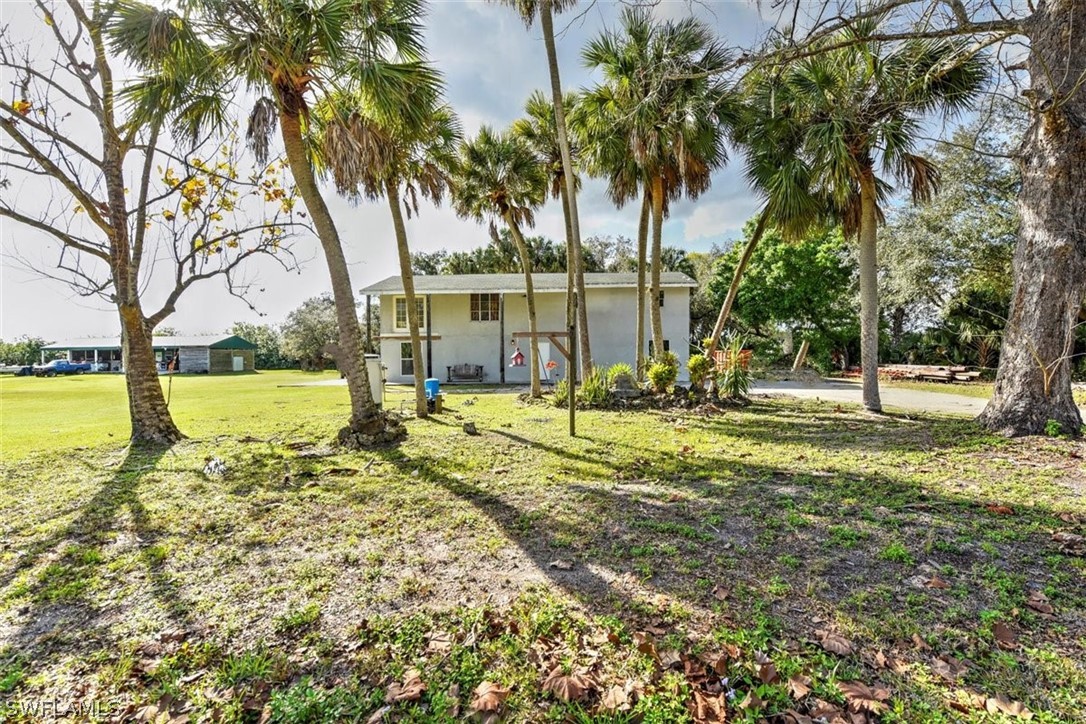 5320 Obannon Road Fort Myers, FL 33905 - Photo 24 of 28 a view of a swimming pool with a patio and a yard