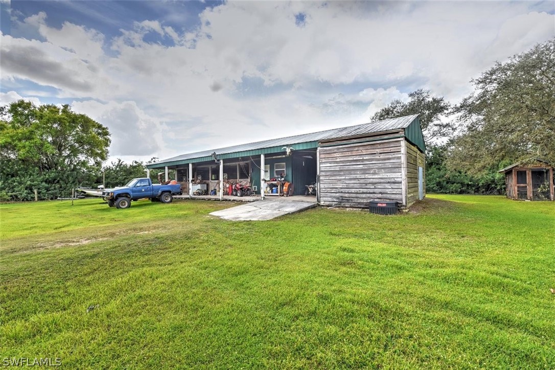 5320 Obannon Road Fort Myers, FL 33905 - Photo 27 of 28 a view of a house with a backyard porch and sitting area