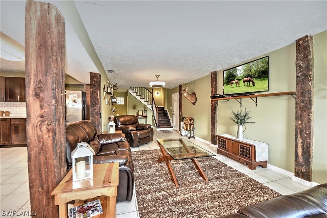 5320 Obannon Road Fort Myers, FL 33905 - Photo 5 of 28 a living room with furniture and a rug