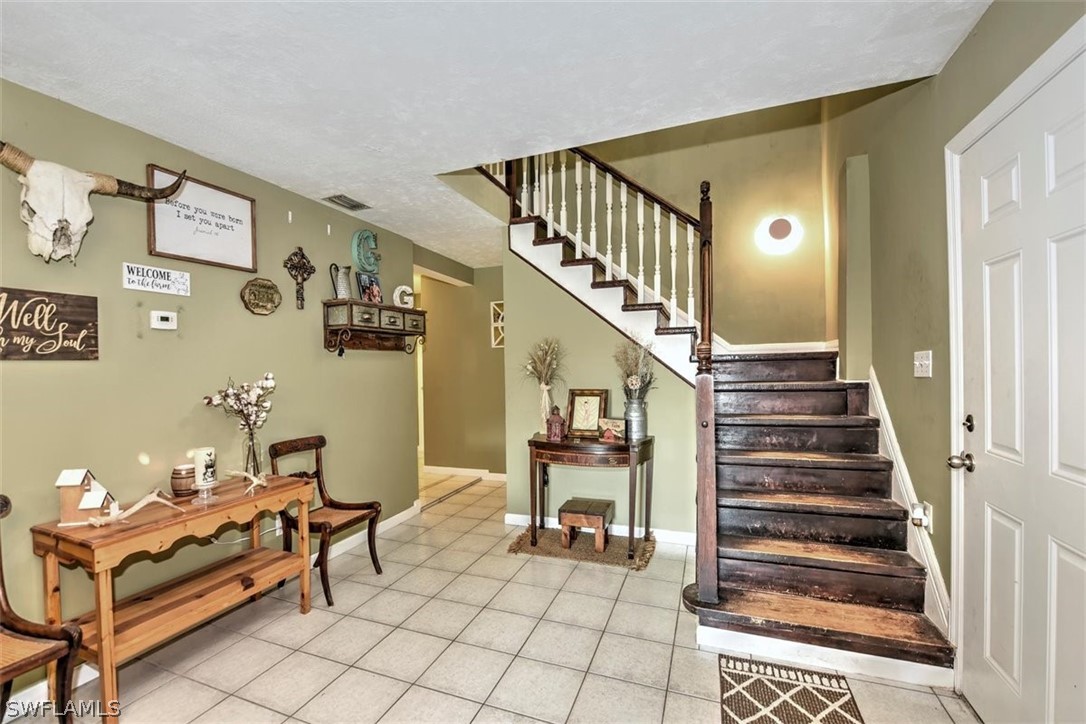 5320 Obannon Road Fort Myers, FL 33905 - Photo 10 of 28 a living room with furniture and stairs