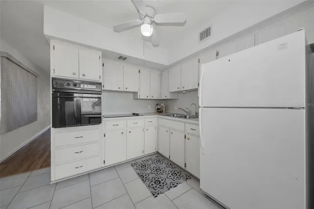 a view of a livingroom with furniture a flat screen tv and wooden floor