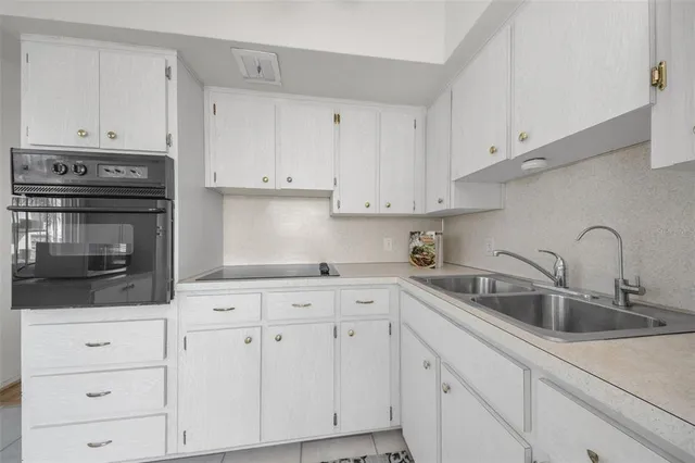 a view of empty room with wooden floor and ceiling fan