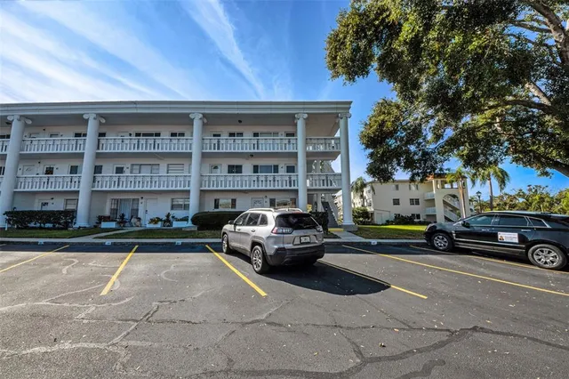 a view of a living room and a kitchen with stainless steel appliances