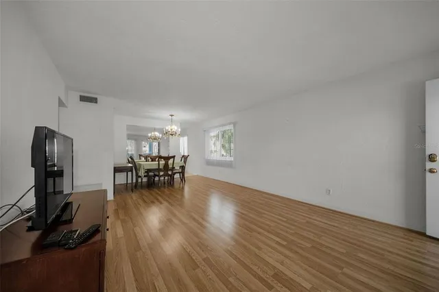 a dining room with furniture and chandelier