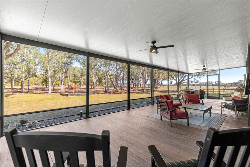 4120 Southwest 199th Court Dunnellon, FL 34431 - Photo 19 of 82 a view of a dining room with furniture large windows and wooden floor