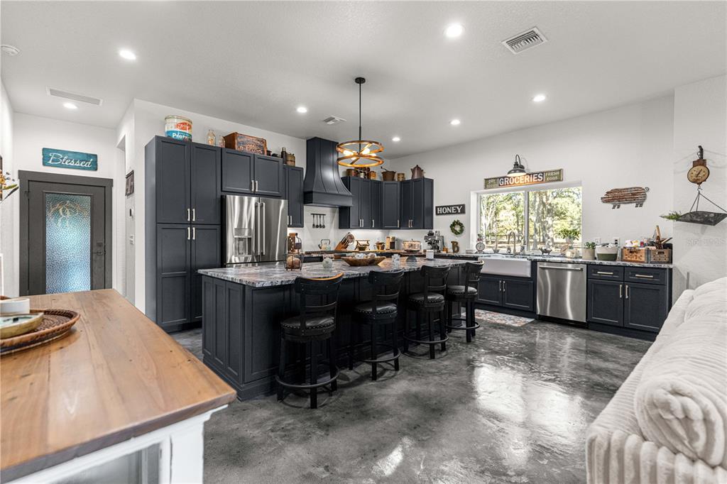4120 Southwest 199th Court Dunnellon, FL 34431 - Photo 31 of 82 a kitchen with kitchen island granite countertop a sink cabinets and stainless steel appliances