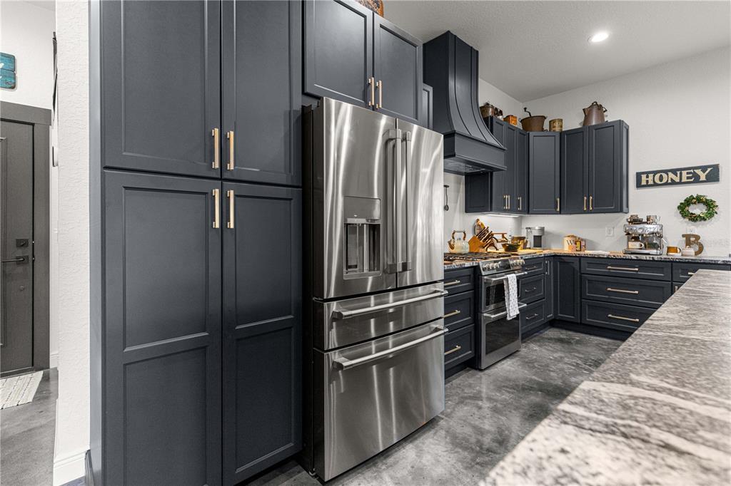 4120 Southwest 199th Court Dunnellon, FL 34431 - Photo 32 of 82 a kitchen with stainless steel appliances granite countertop a refrigerator and a sink