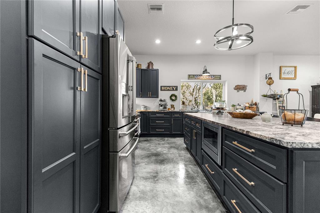 4120 Southwest 199th Court Dunnellon, FL 34431 - Photo 33 of 82 a kitchen with stainless steel appliances granite countertop a refrigerator and a sink