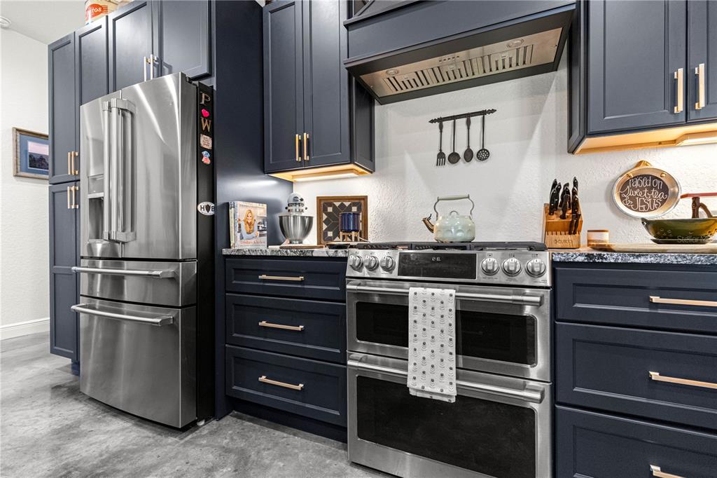 4120 Southwest 199th Court Dunnellon, FL 34431 - Photo 35 of 82 a kitchen with stainless steel appliances granite countertop a refrigerator and a stove