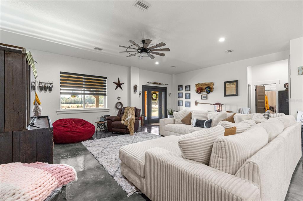 4120 Southwest 199th Court Dunnellon, FL 34431 - Photo 39 of 82 a living room with furniture ceiling fan and a window